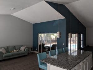 dark teal accent wall in open living room
