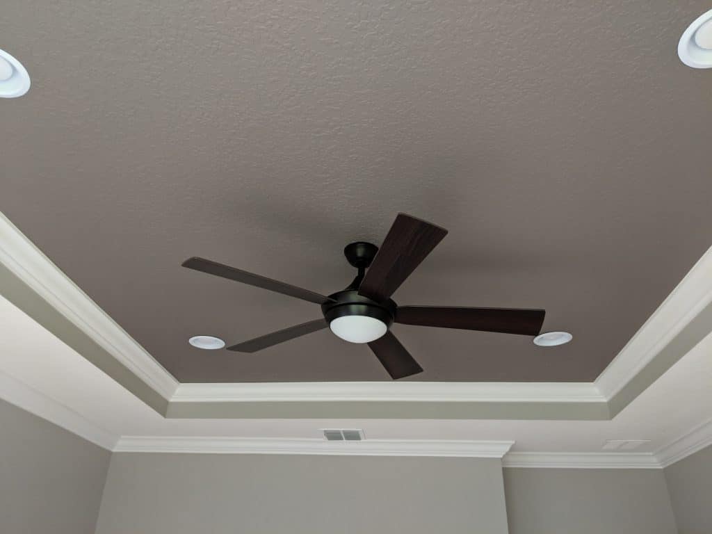 Grey tray ceiling in room with light grey walls and white trim
