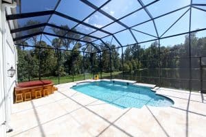 screened in pool with view of trees