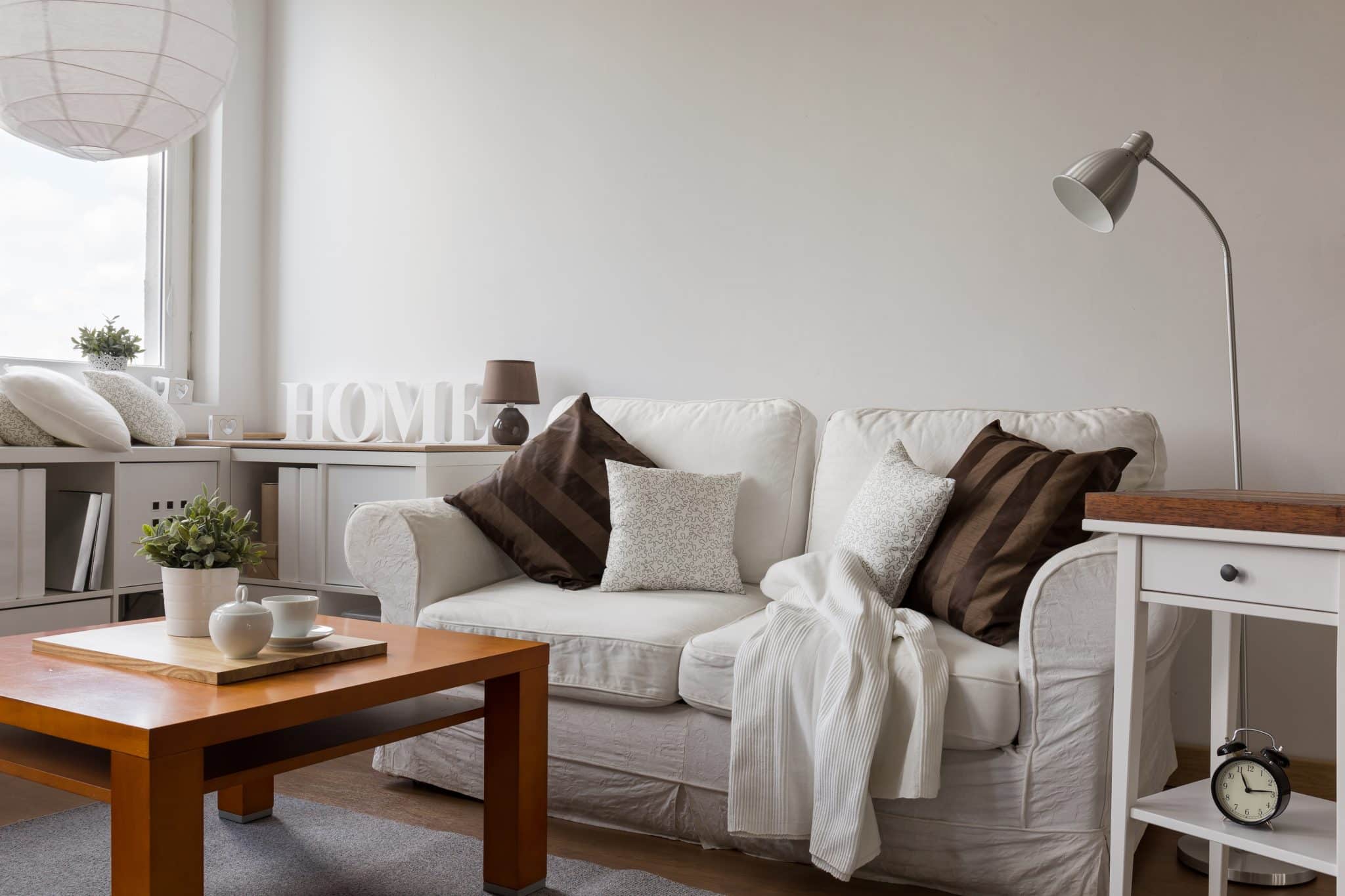 A small, cozy living room with warm, white walls.